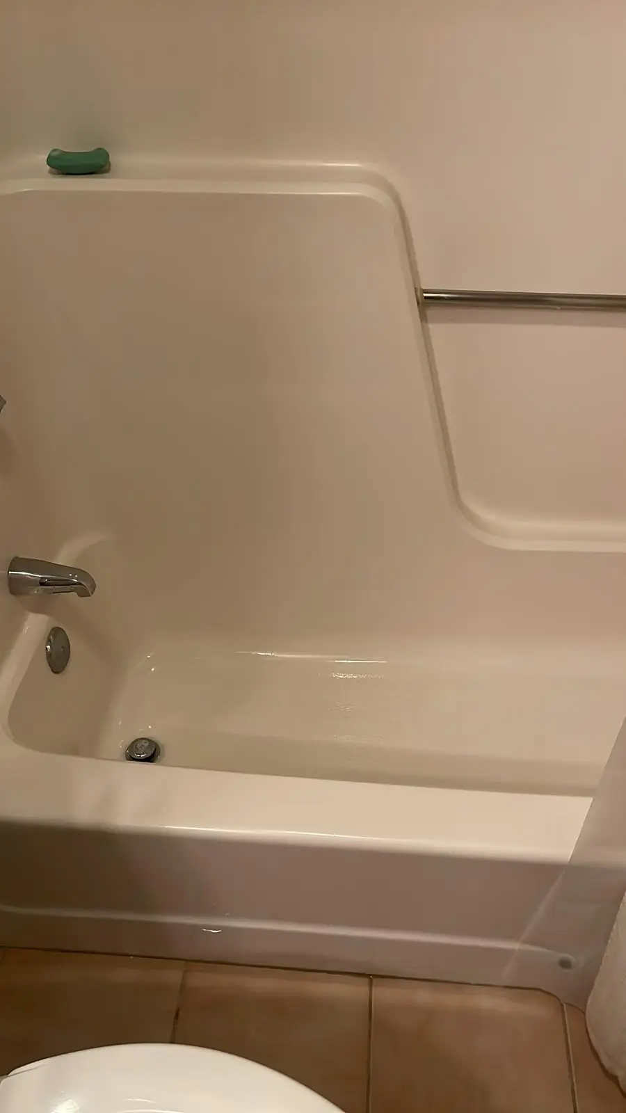 Clean bathtub with shower rod after a deep cleaning in Clinton, MA