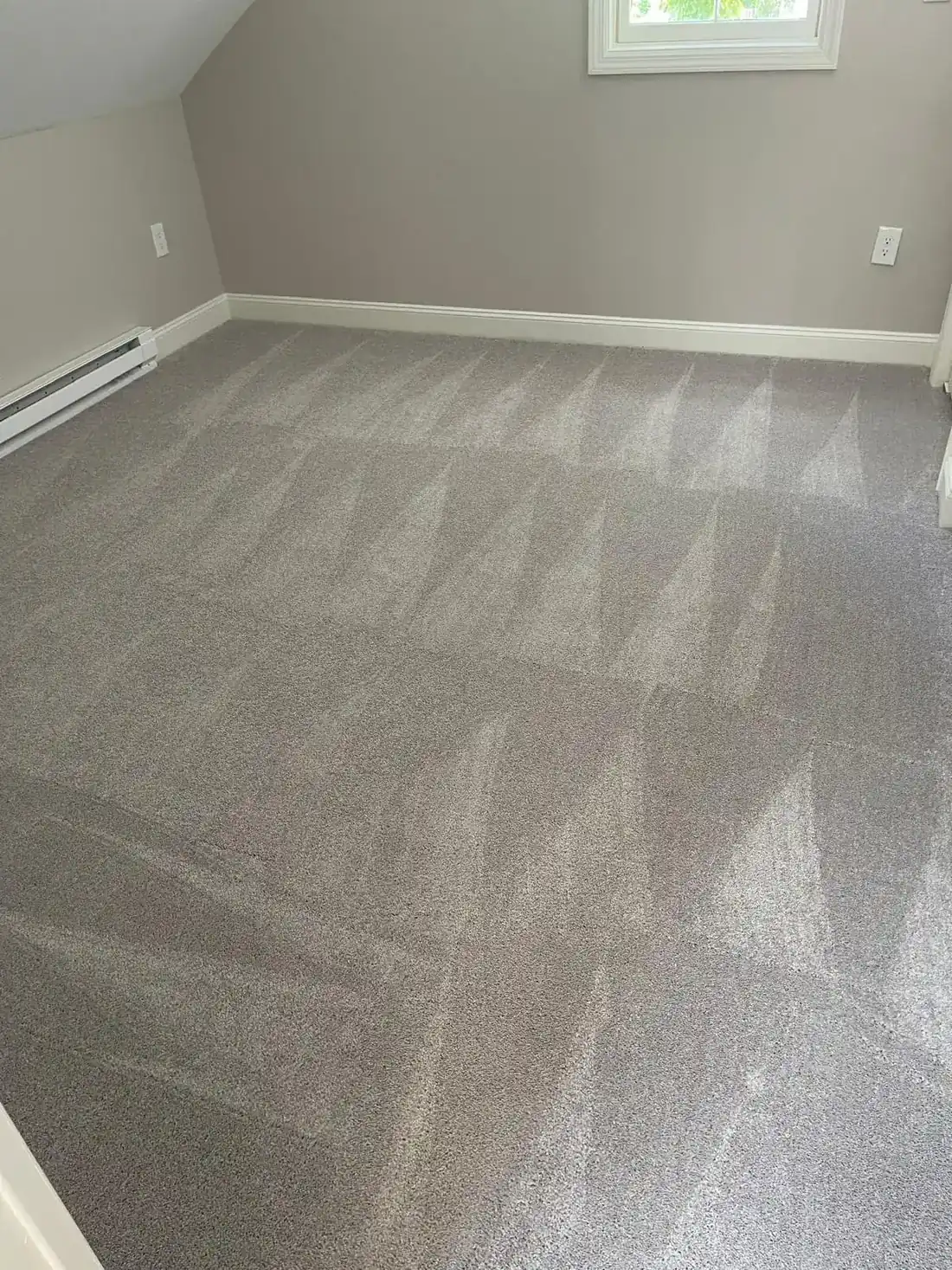 Freshly cleaned carpet around a floor vent after a move-out cleaning in Clinton, MA