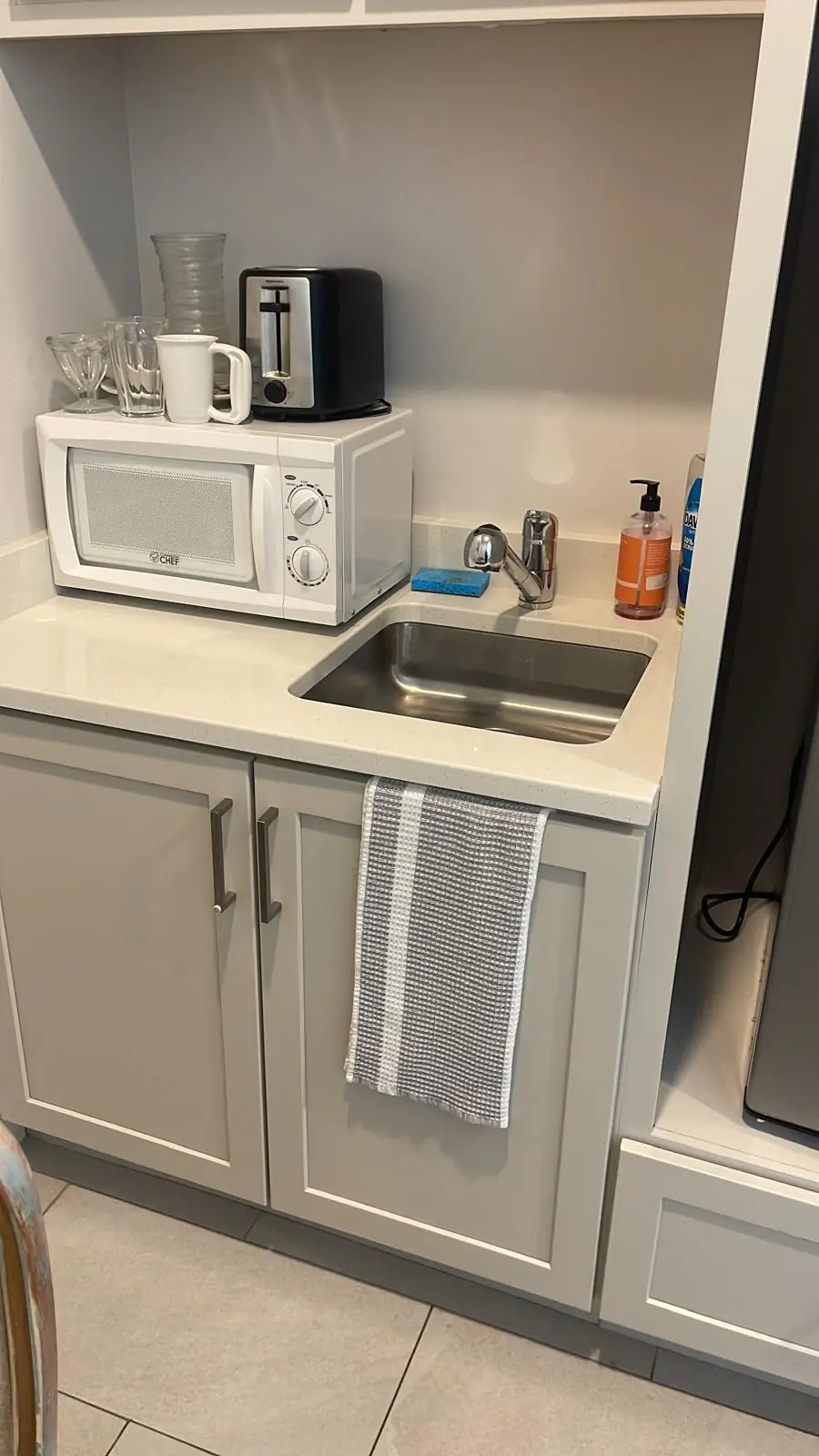 Clean kitchenette sink and counter after a house cleaning in Clinton, MA